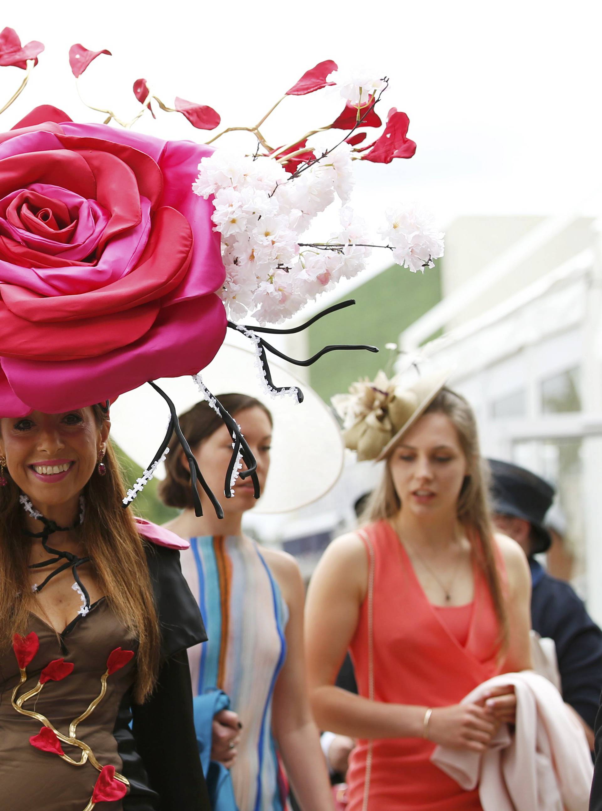 Britain Horse Racing Ladies Day Racegoer wears hat