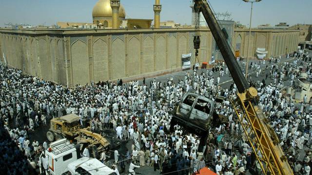 FILE PHOTO: Burned-out car removed from front of main mosque in Najaf