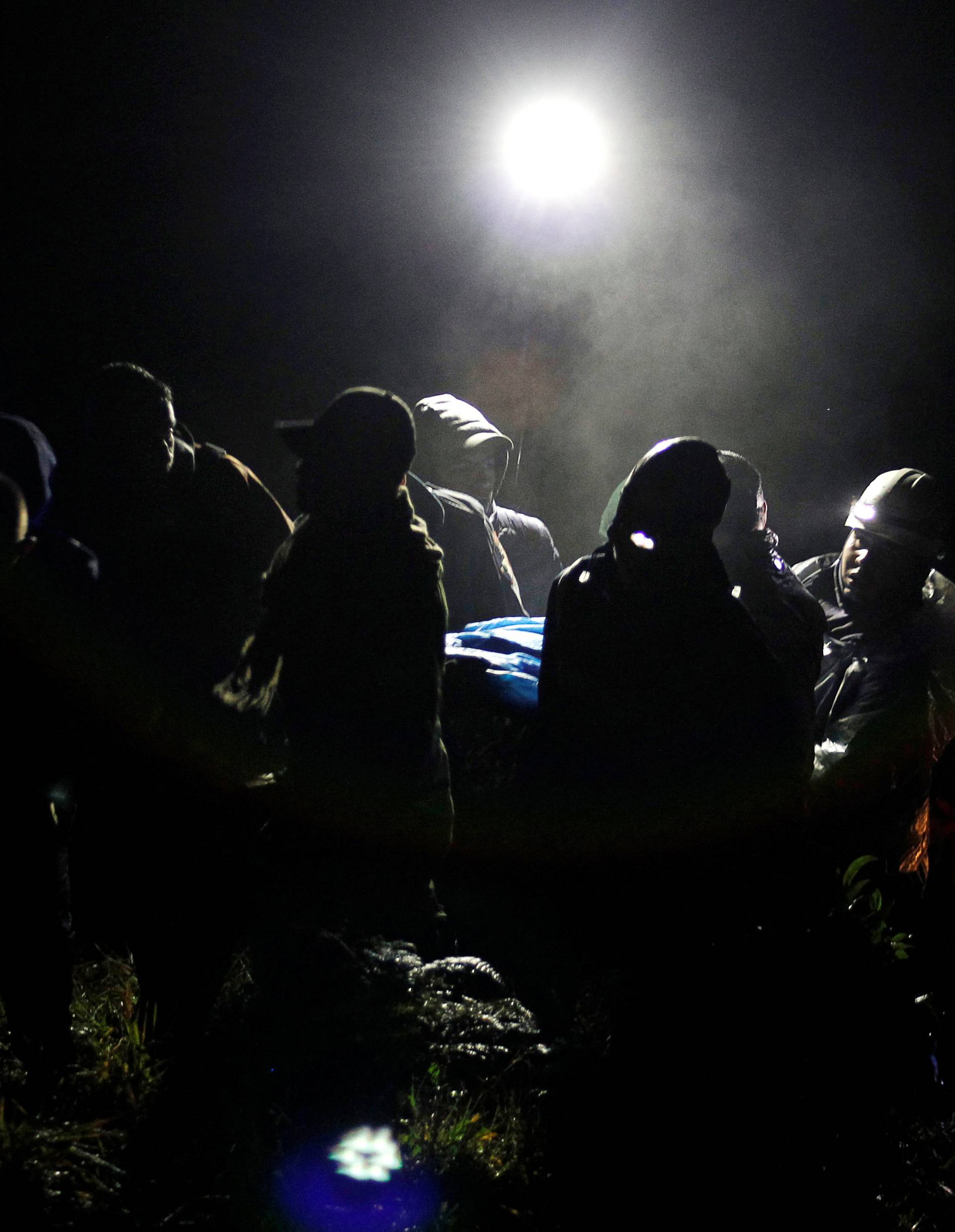 Rescue workers carry the body of a victim from a plane that crashed into Colombian jungle with Brazilian soccer team Chapecoense near Medellin