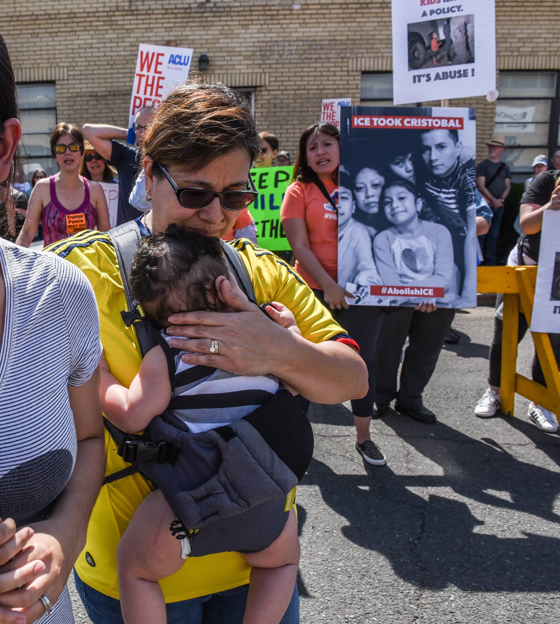 People participate in a protest against recent U.S. immigration policy that separates children from their families when entering the United States as undocumented immigrants in front of a Homeland Security facility in Elizabeth