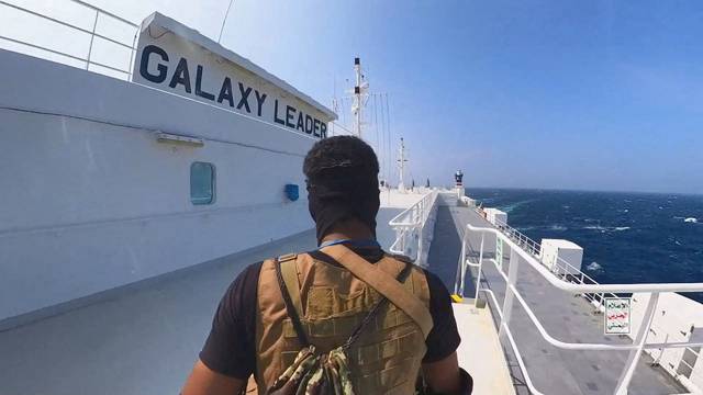 Houthi fighter stands on the Galaxy Leader cargo ship in the Red Sea