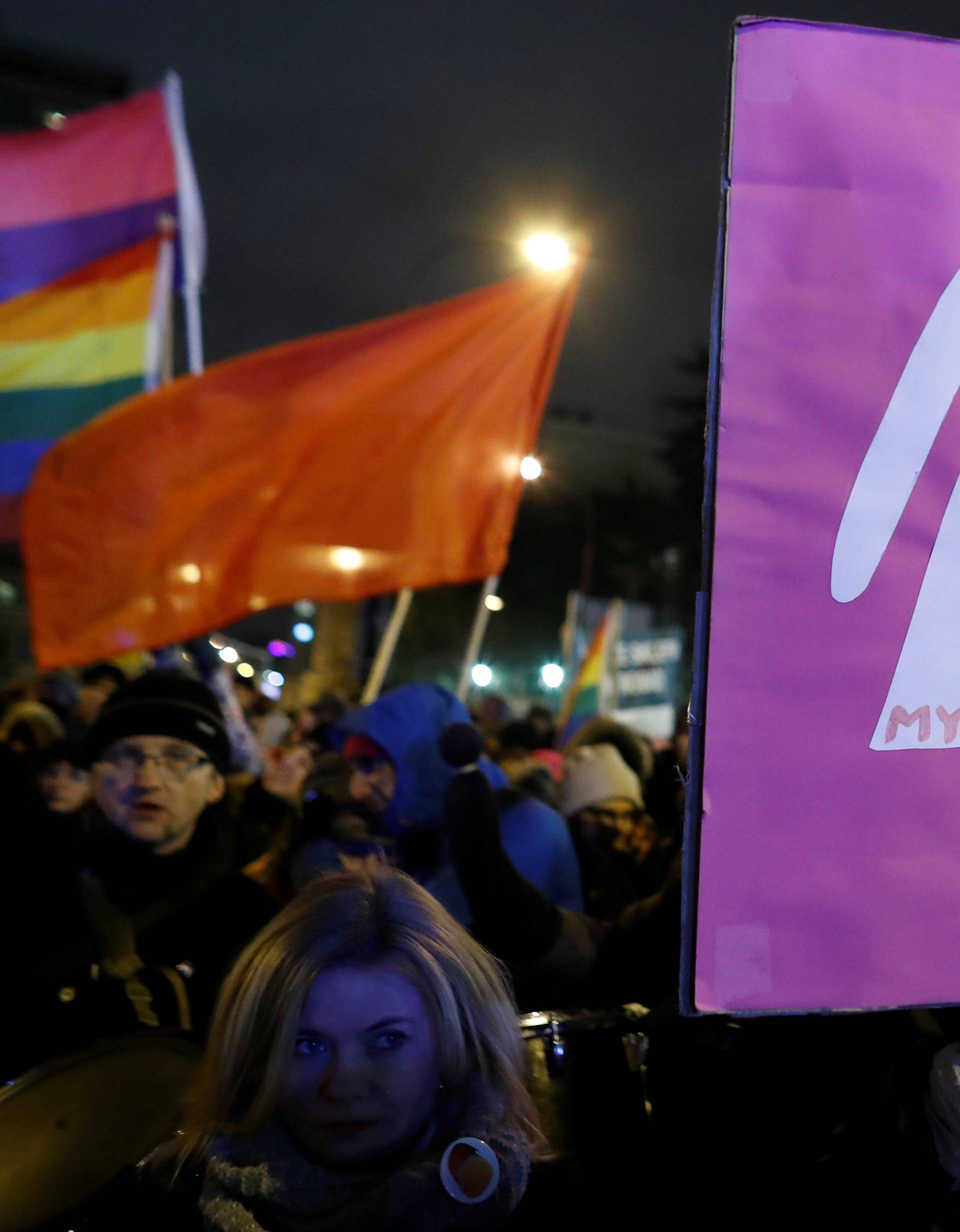 People gather to protest against plans to further restrict abortion laws in front of the Parliament in Warsaw