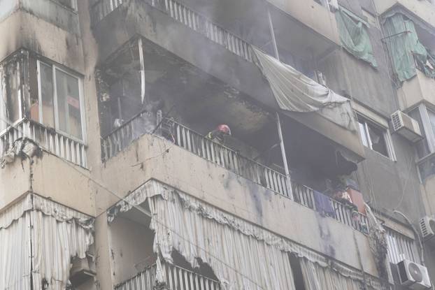 Members of the Lebanese Civil Defence inspect a building following an Israeli air strike in Beirut