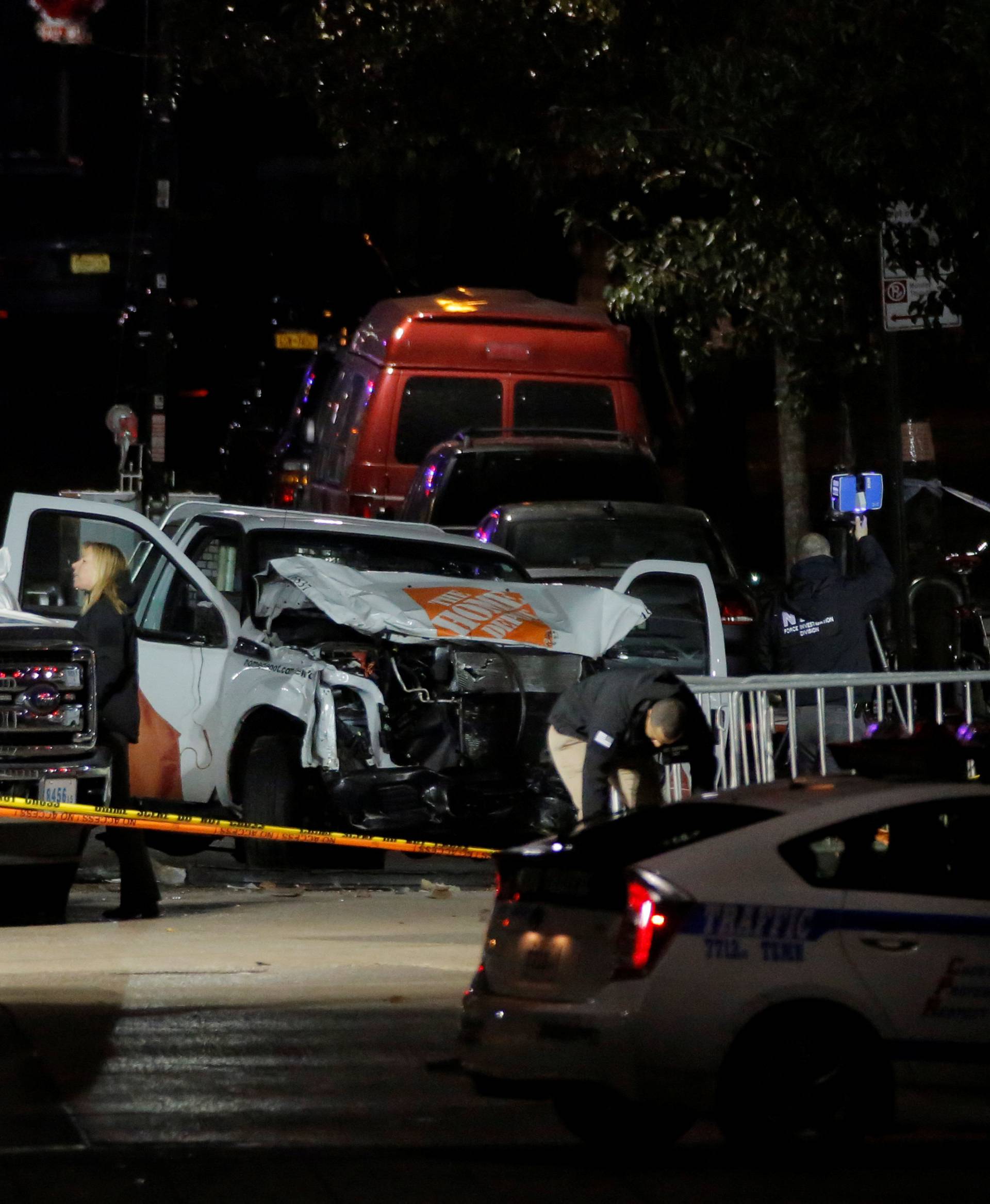 Police investigate a pickup truck used in an attack on the West Side Highway in Manhattan