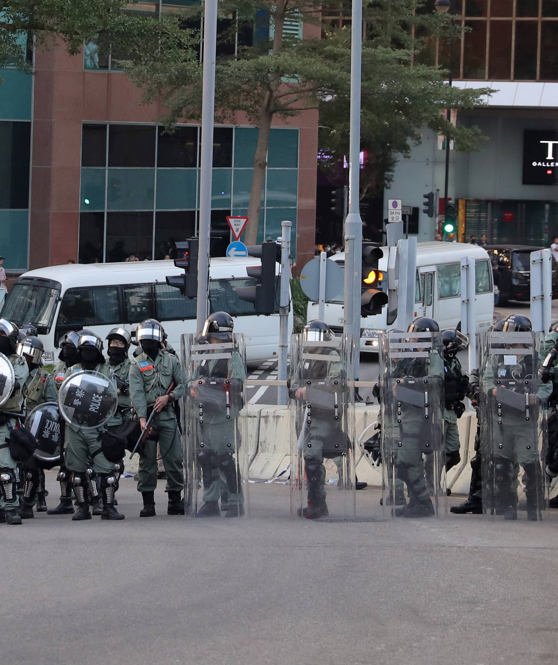 Riot police officers block a street during the "Lest We Forget" rally in Hong Kong