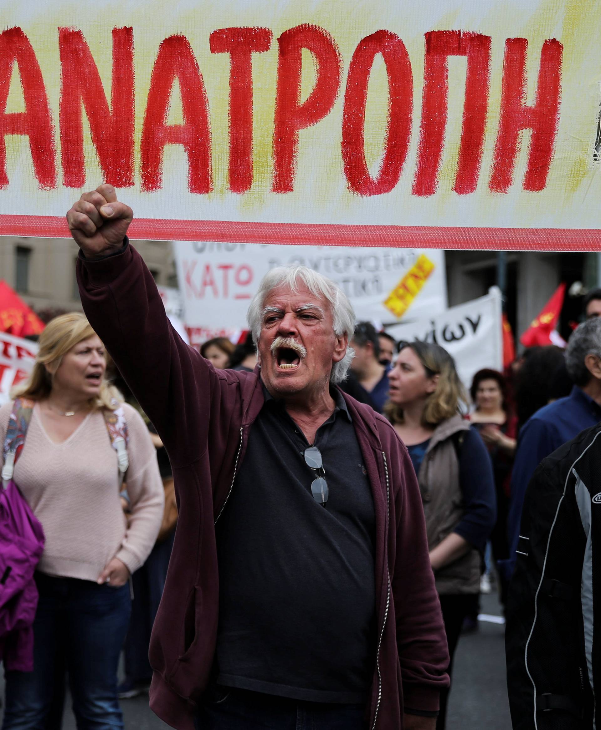 Demonstrators shouts slogans during a demonstration marking a 24-hour general strike against the latest round of austerity in Athens