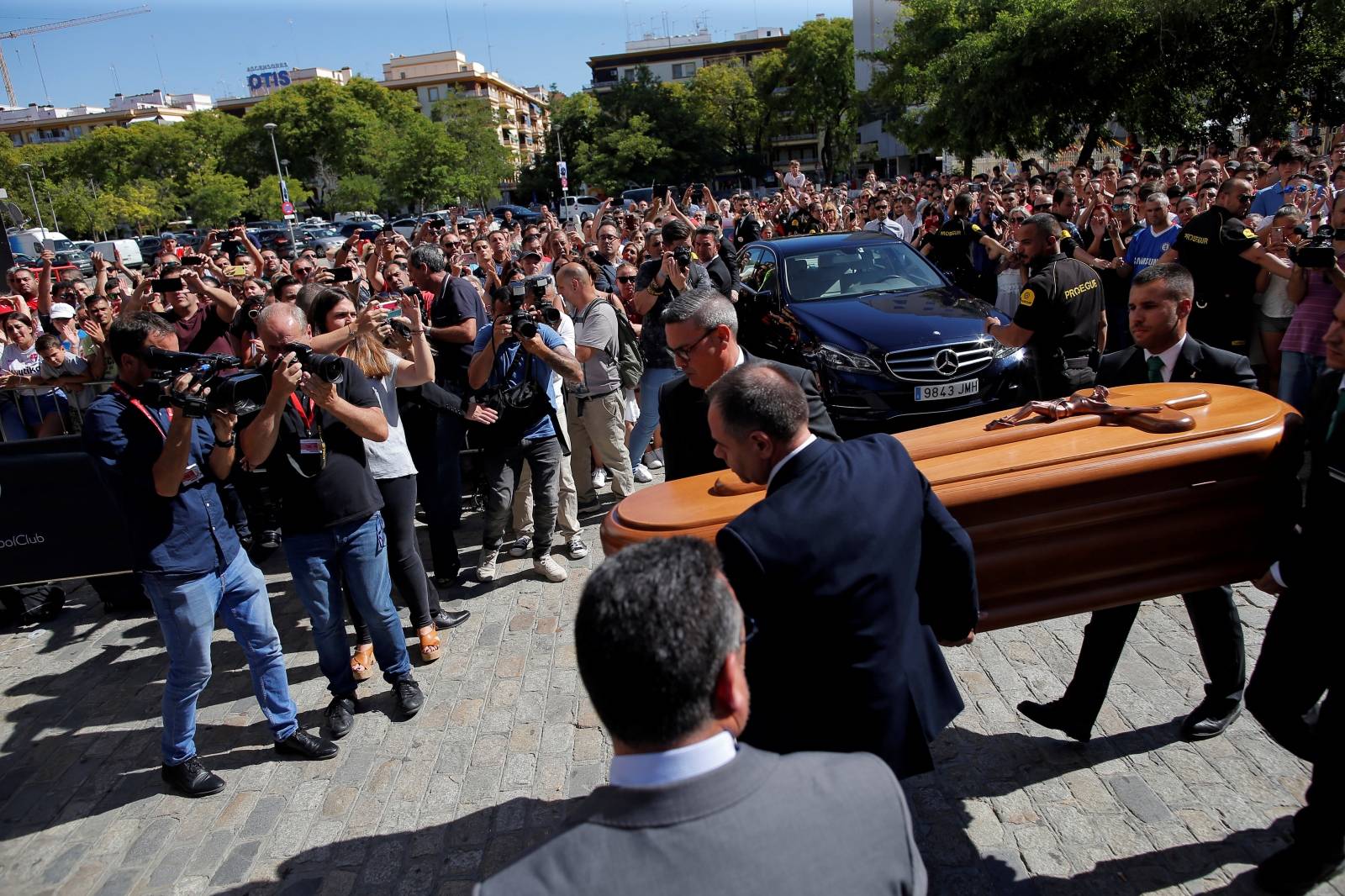 Men carry the coffin containing the body of Spanish footballer Reyes in Seville