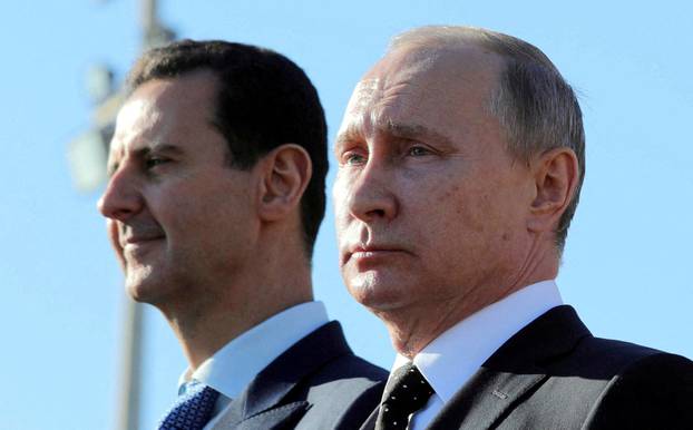 FILE PHOTO: FILE PHOTO: Russian President Putin and Syrian President Bashar al-Assad visit the Hmeymim air base in Latakia Province