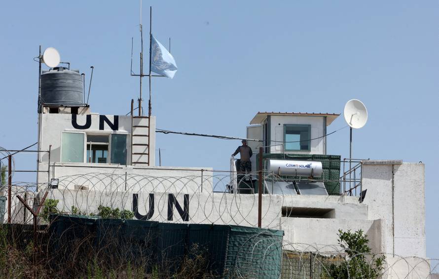 FILE PHOTO: A U.N. peacekeeper of the United Nations Interim Force in Lebanon (UNIFIL) stands at his post in the village of Markaba