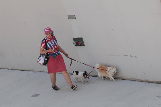 Trump supporter walks with their dogs, on the first day of the Republican National Convention (RNC) in Milwaukee