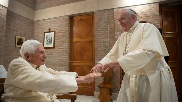 FILE PHOTO: Pope Francis and Pope Emeritus Benedict XVI meet with new cardinals at the Vatican