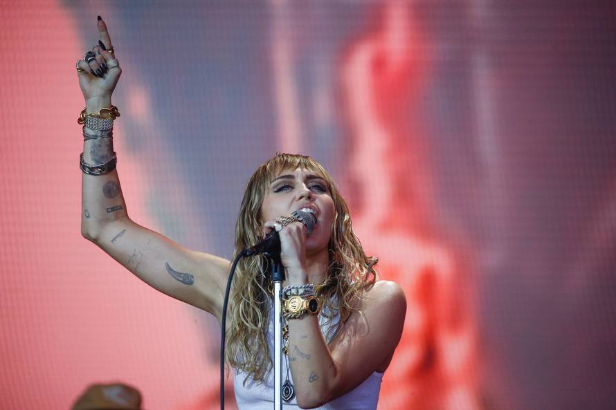 Kylie Minogue watches American singer Miley Cyrus perform on the Pyramid Stage during Glastonbury Festival in Somerset