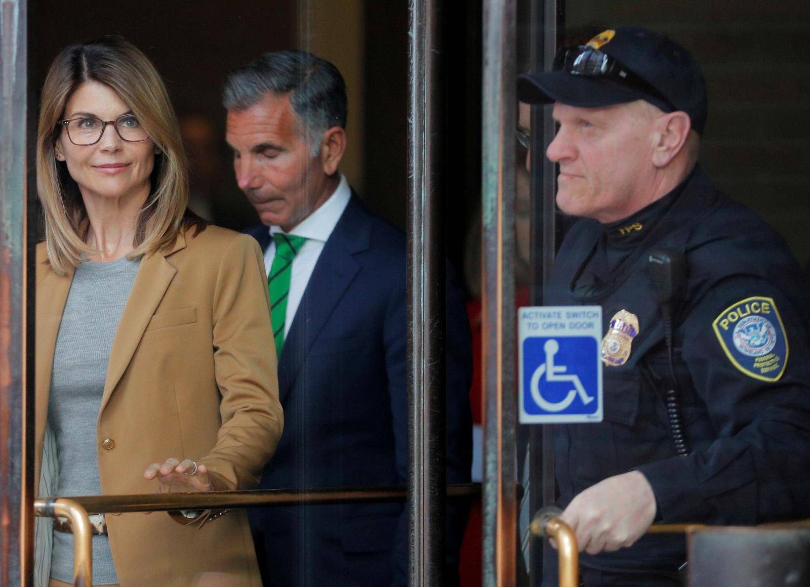 FILE PHOTO: Actor Lori Loughlin, and husband, fashion designer Mossimo Giannulli, facing charges in a nationwide college admissions cheating scheme, leave federal court in Boston