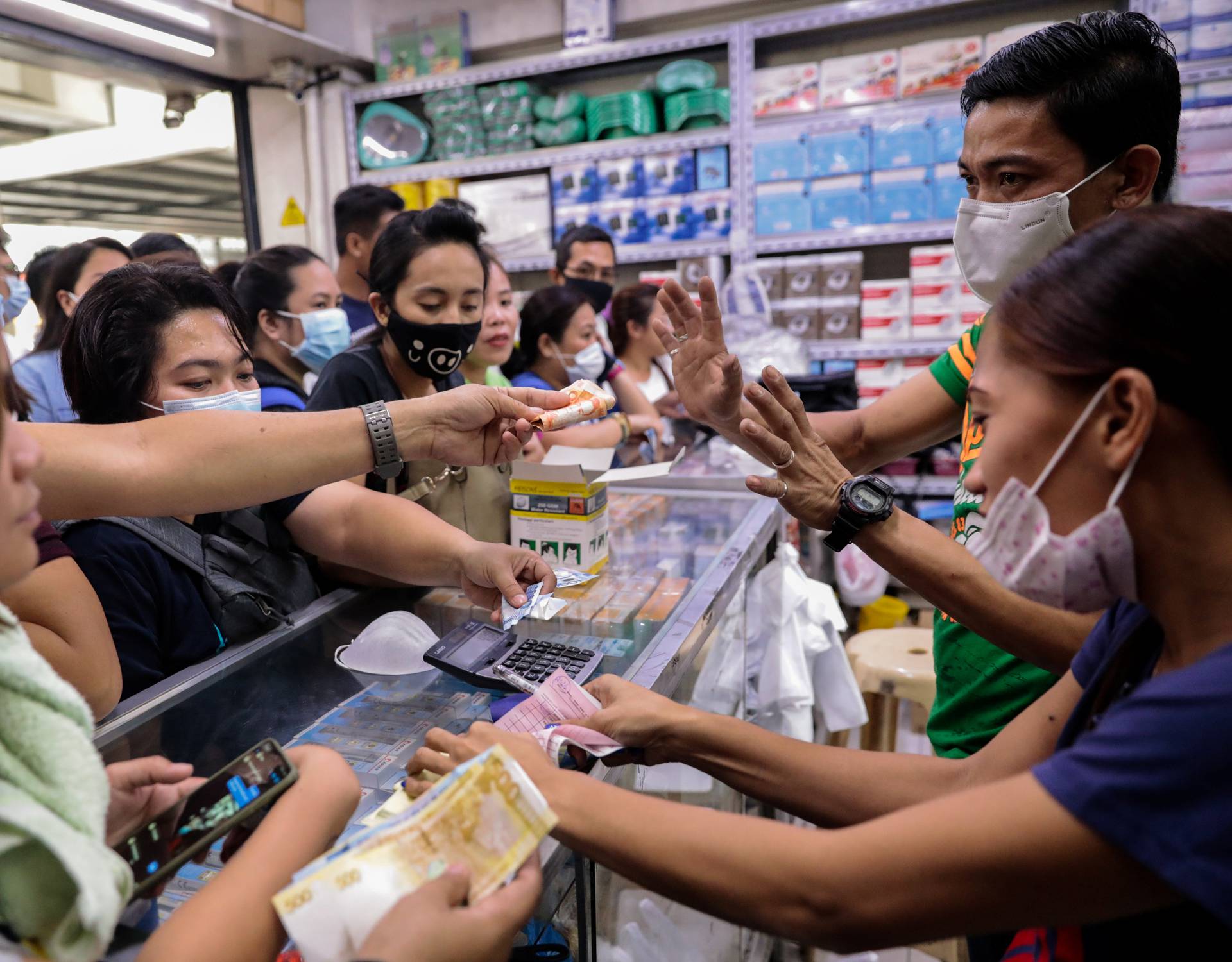 People scramble to buy face masks in a medical supply store a day after Philippine government confirmed first novel coronavirus case