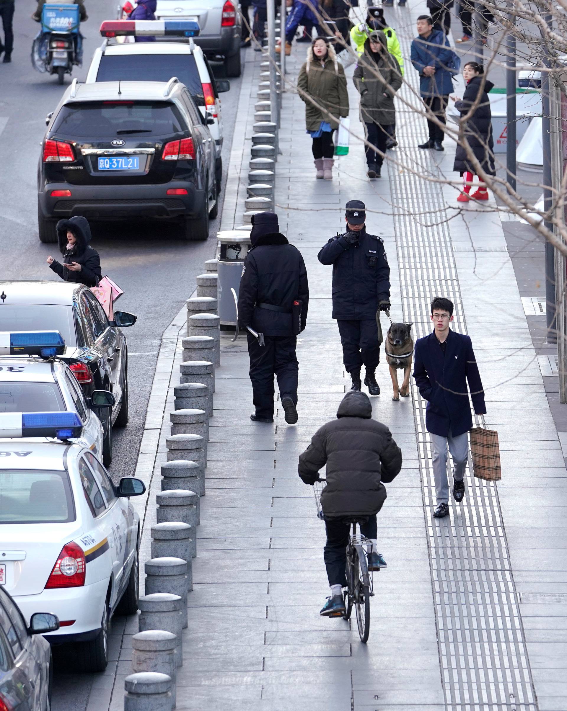 Police patrol outside the Joy City Mall in the Xidan district after a knife attack in Beijing