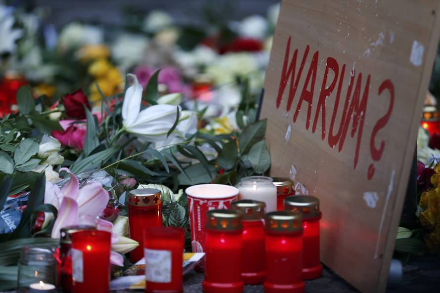 A placard reading "Why?" is placed at the Christmas market in Berlin