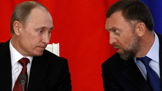 FILE PHOTO: Russia's President Vladimir Putin and Russian tycoon Oleg Deripaska attend a signing ceremony after talks with the Chinese delegation at the Kremlin in Moscow