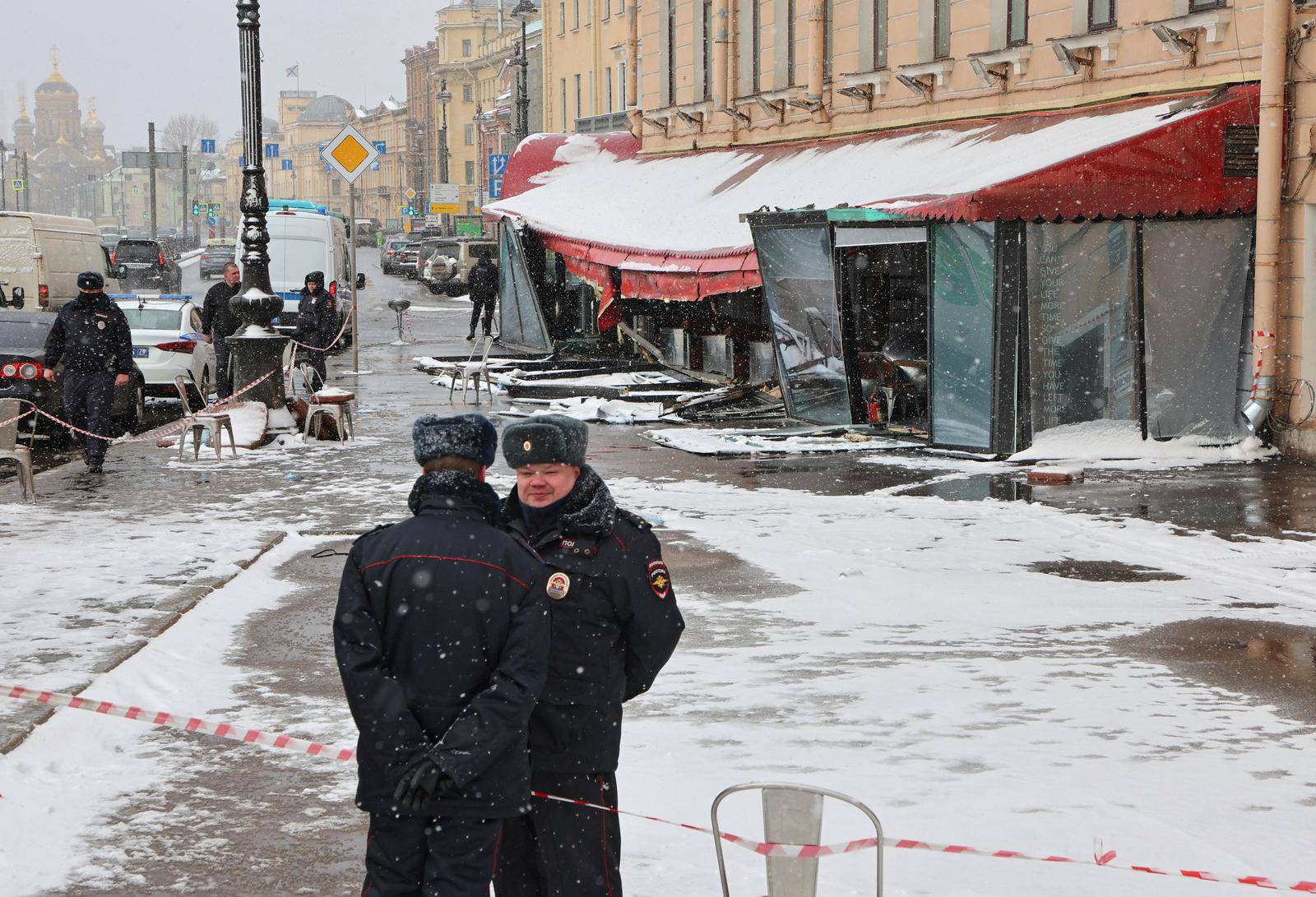 Police officers stand guard at the scene of the cafe explosion in Saint Petersburg