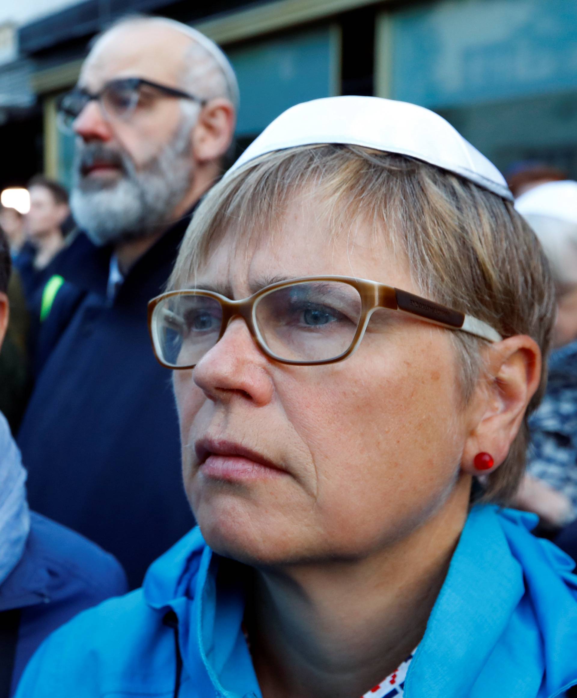 People wear kippas as they attend a demonstration in front of a Jewish synagogue in Berlin