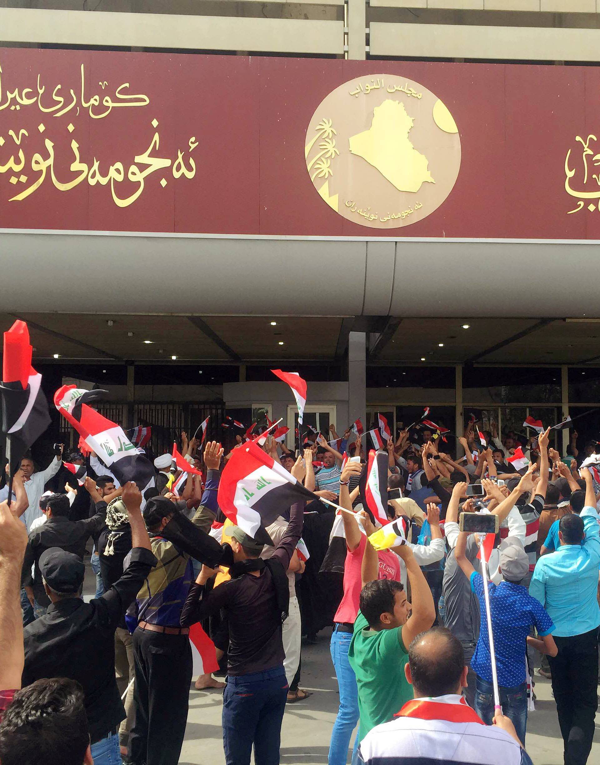 Followers of Iraq's Shi'ite cleric Moqtada al-Sadr are seen at the parliament building as they storm Baghdad's Green Zone 