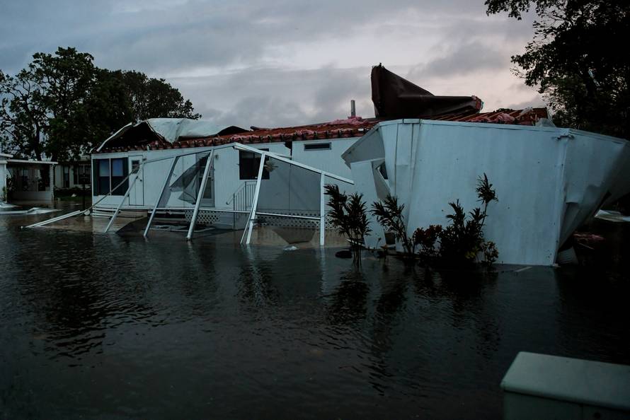 Flood water from Hurricane Irma surround a damaged mobile home in Bonita Springs