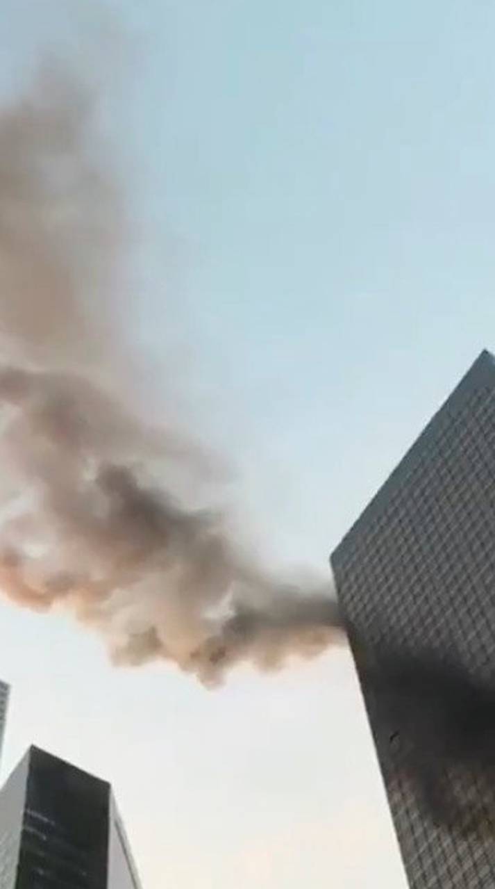 A smoke is seen rising from the roof of Trump Tower, in New York