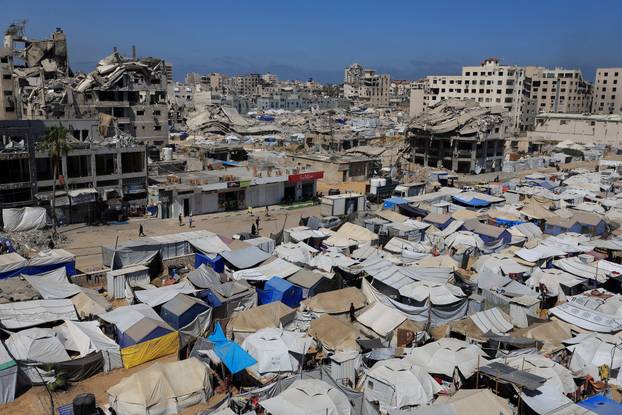 Palestinians displaced by the Israeli military offensive, shelter in tents, in Gaza