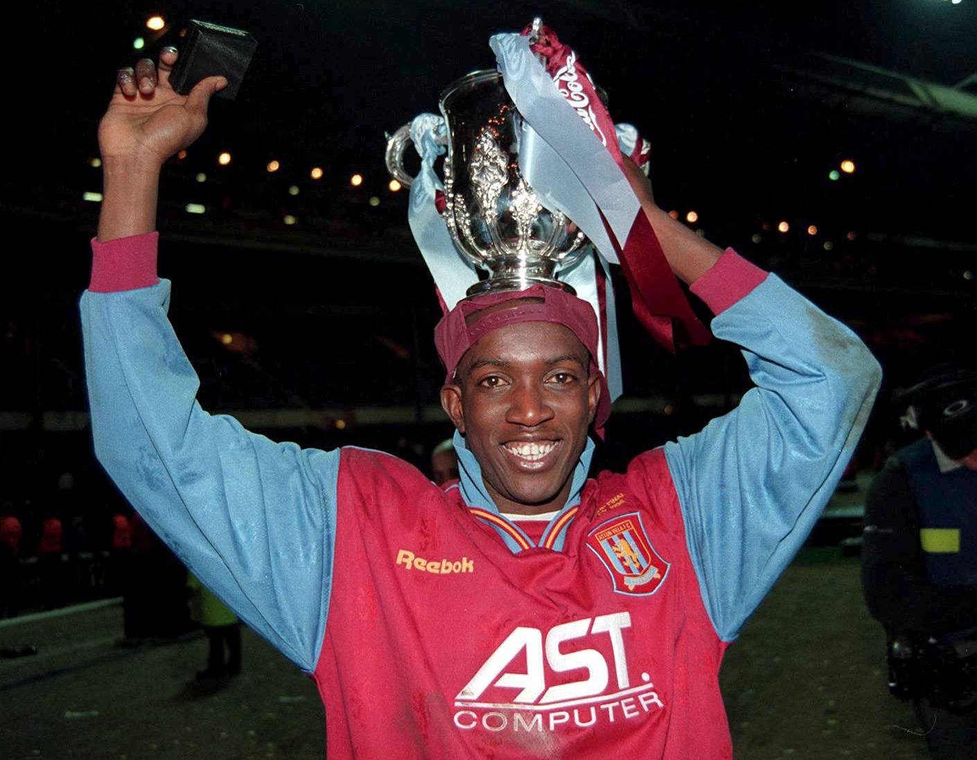 FILE PHOTO: Aston Villa's Dwight Yorke celebrates after they beat Leeds United in the League Cup final at Wembley Stadium