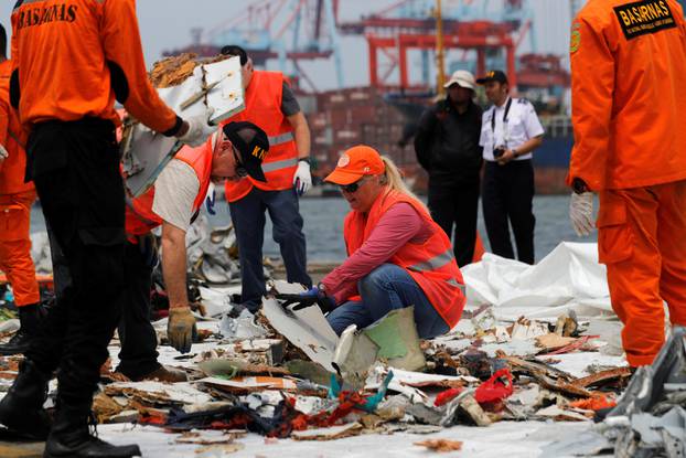 Personnel from National Transportation Safety Board examine debris from Lion Air flight JT610 at Tanjung Priok port in Jakarta