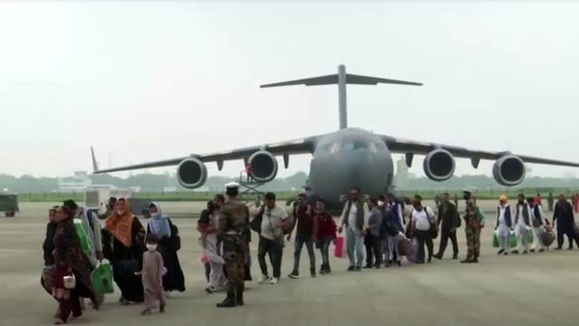 People evacuated from Afghanistan get off a plane in Ghaziabad