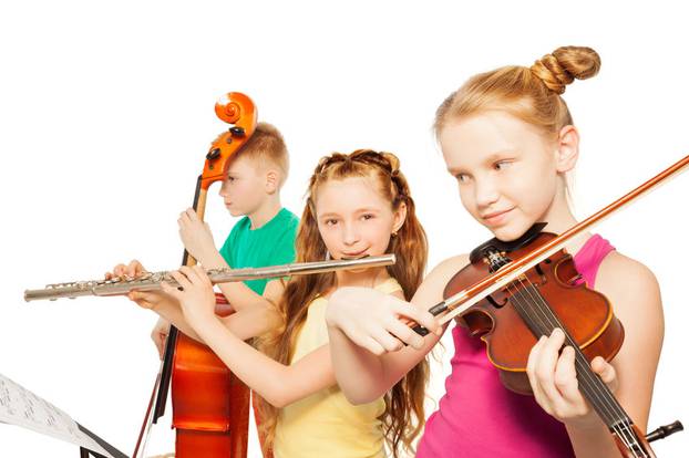 Close-up view of kids playing musical instruments