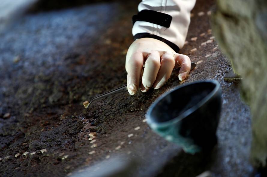 An archaeologist works on a mosaic in the House of Lovers "Casa degli Amanti\