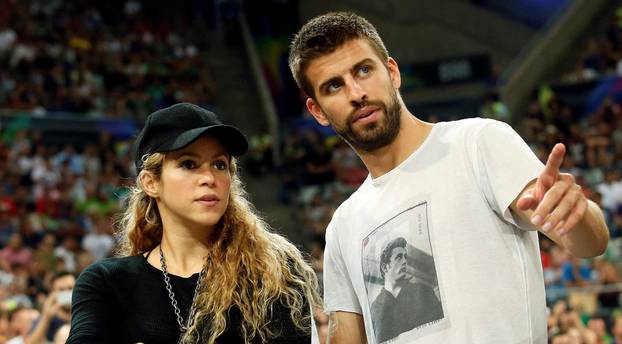 FILE PHOTO: Colombian singer Shakira and her partner, Barcelona soccer player Pique, attend the Basketball World Cup quarter-final game between the U.S. and Slovenia in Barcelona