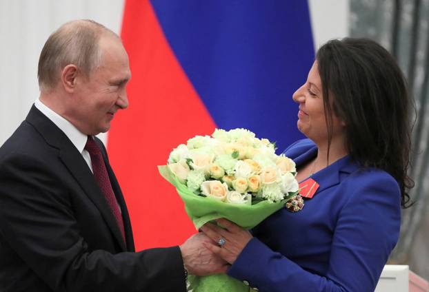 FILE PHOTO: Russian President Putin and editor-in-chief of broadcaster RT Simonyan attend an awarding ceremony in Moscow