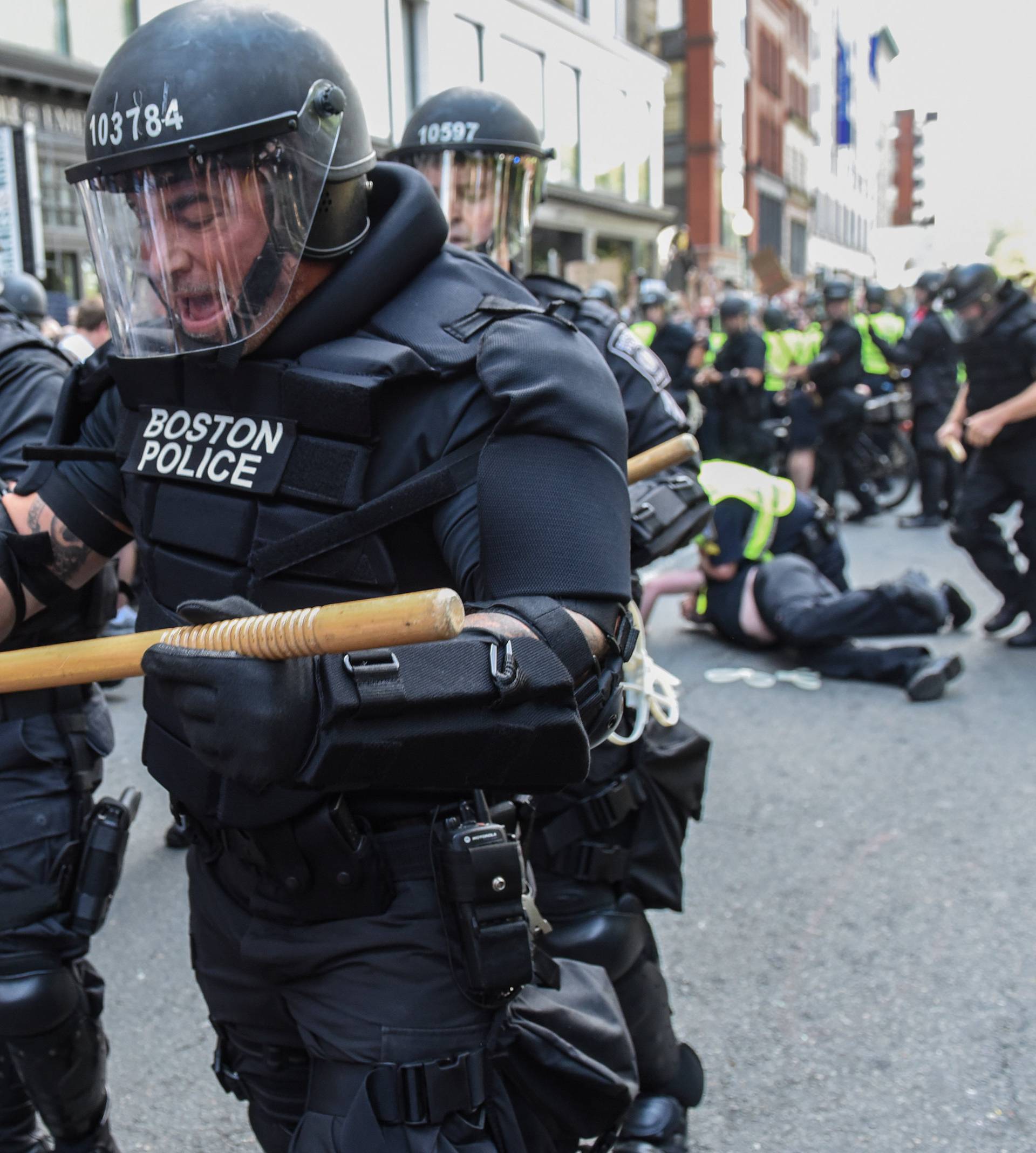 Boston Police officers react as a crowd of counter protesters clashes with them outside of the Boston Commons and the Boston Free Speech Rally in Boston, Massachusetts