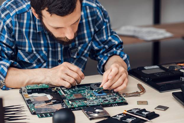 Repairman,Disassembling,Laptop,Motherboard.,Engineer,Fixing,Broken,Computer,At,Work.