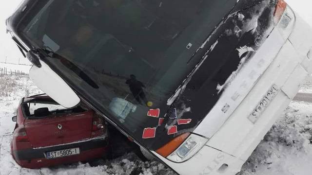 Opasan snijeg: Bus je sletio s ceste i prikliještio automobil