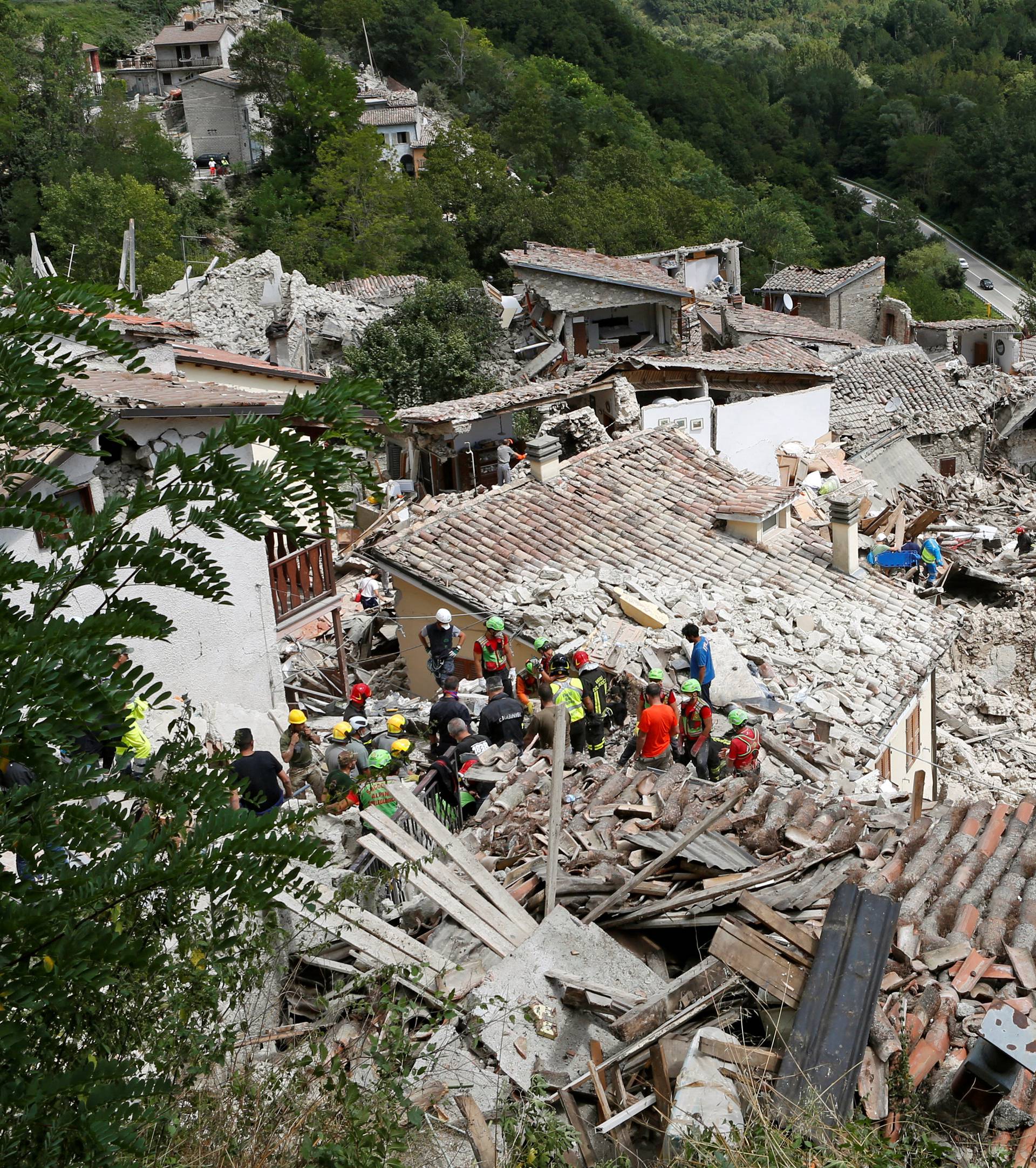 Rescuers work following an earthquake at Pescara del Tronto