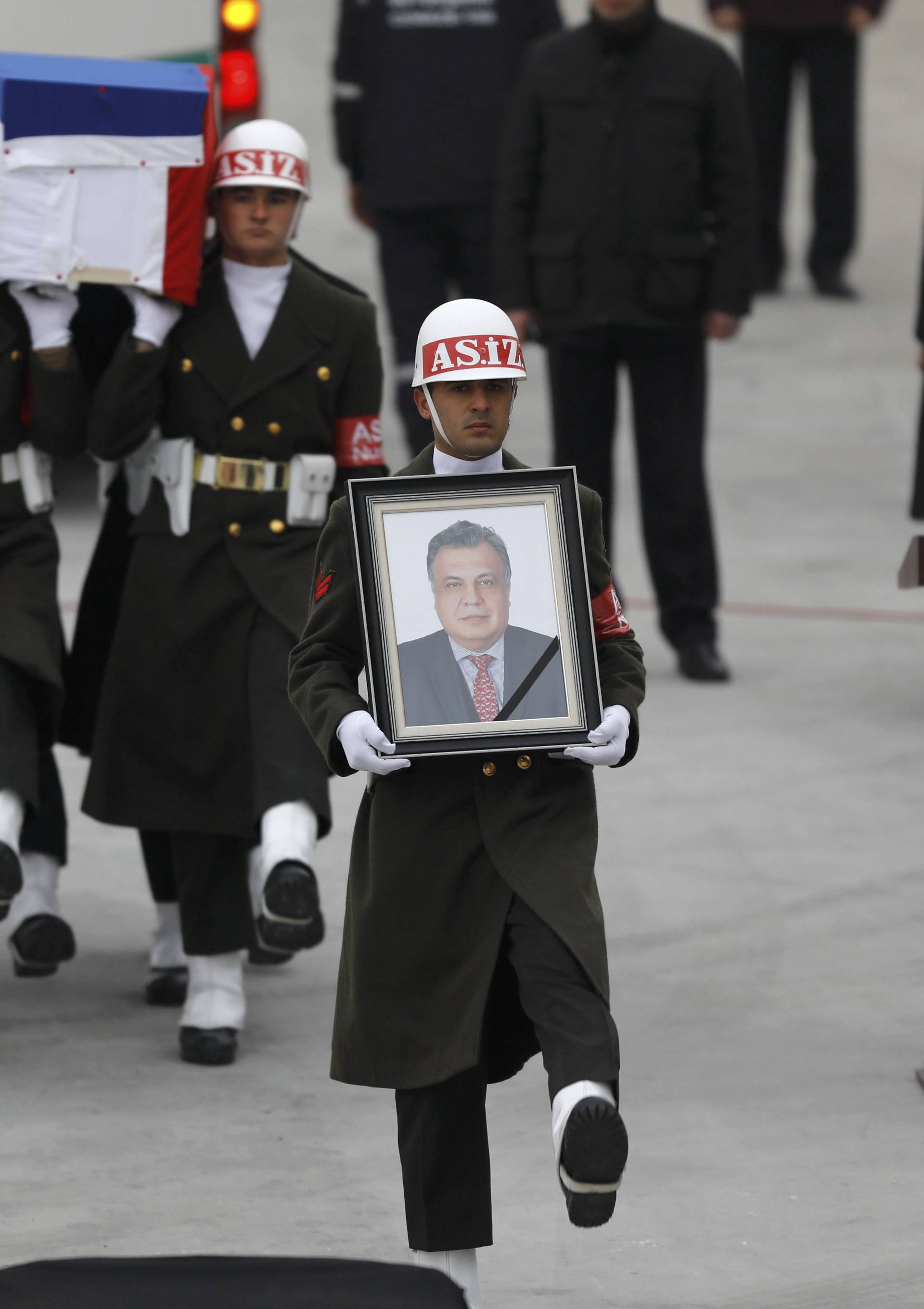 Flag-wrapped coffin of late Russian Ambassador to Turkey Karlov is carried to a plane during a ceremony at Esenboga airport in Ankara