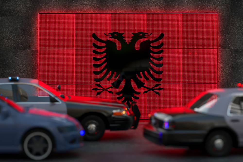 Bright,Digital,Display,Albania,Flag,In,City,As,Cars,Drive