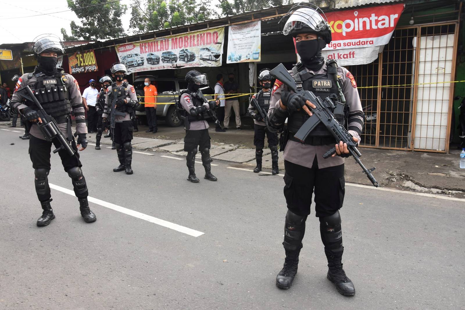 FILE PHOTO: Armed police officers stand guard outside a house of suspected militants during a raid in Jakarta