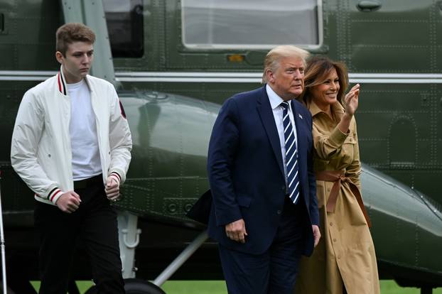 U.S. President Donald Trump, First Lady Melania Trump and their son Barron walk to the White House from Marine One