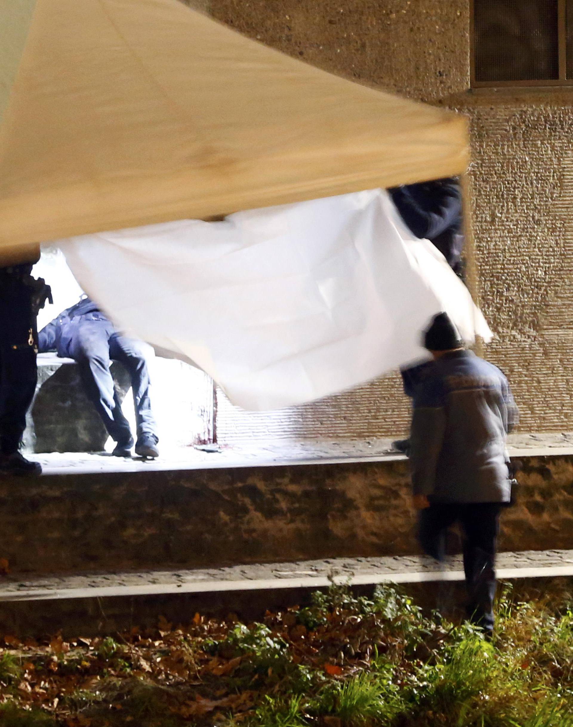 Police cover a body after a shooting outside an Islamic center in central Zurich