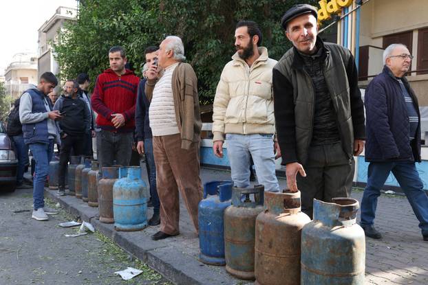 People queue to fill their gas cylinders in Damascus