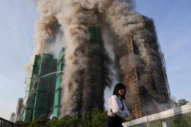 Flames engulf bamboo scaffolding across multiple buildings at Wang Fuk Court housing estate, in Tai Po