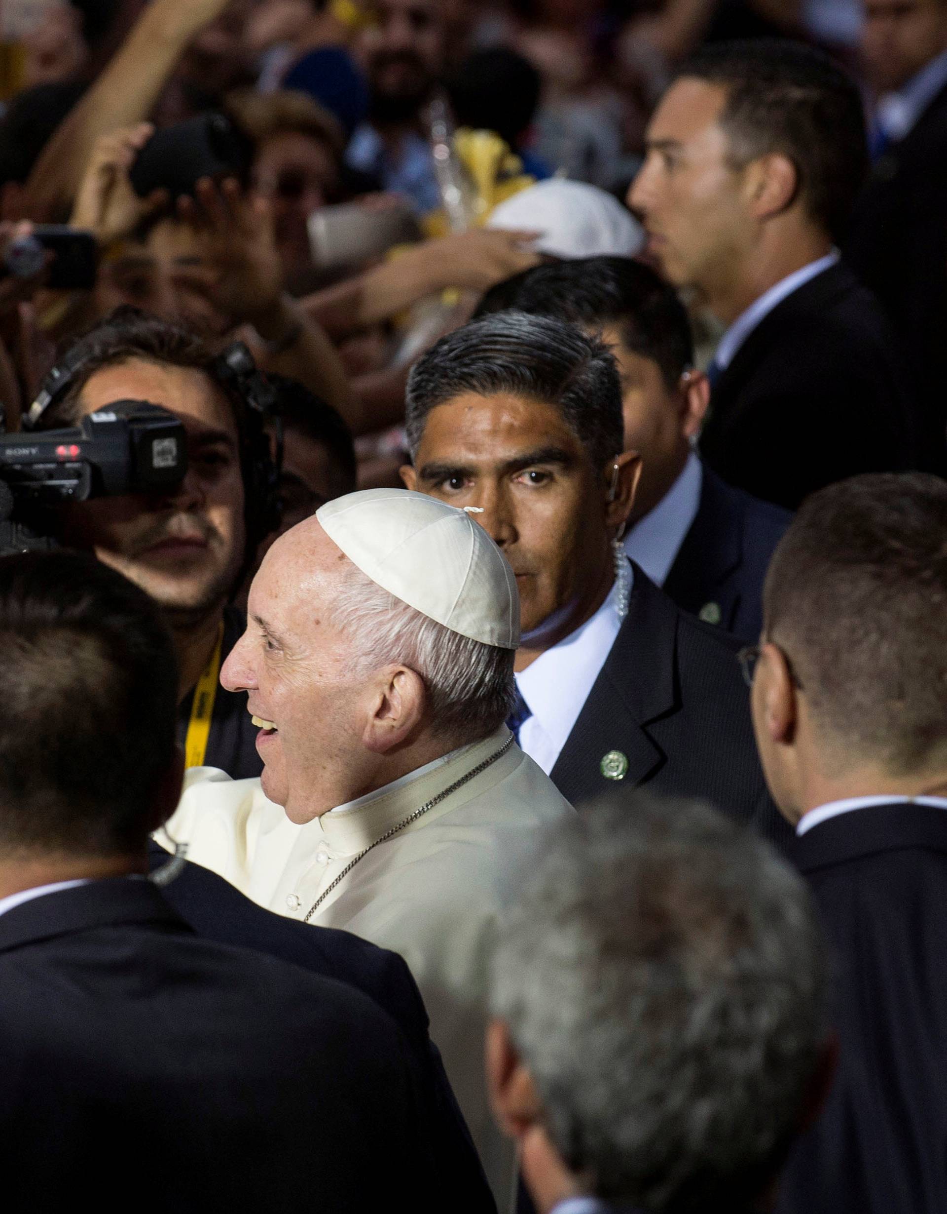 Pope Francis greets people outside the nunciature in Santiago