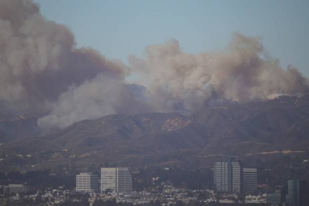 A wildfire burns near Pacific Palisades on the west side of Los Angeles