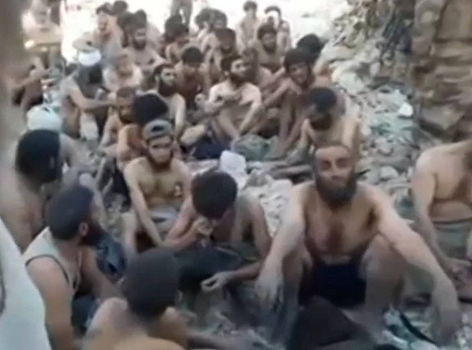 Still image taken from a video shows Islamic State militants surrender in the Old City of Mosul