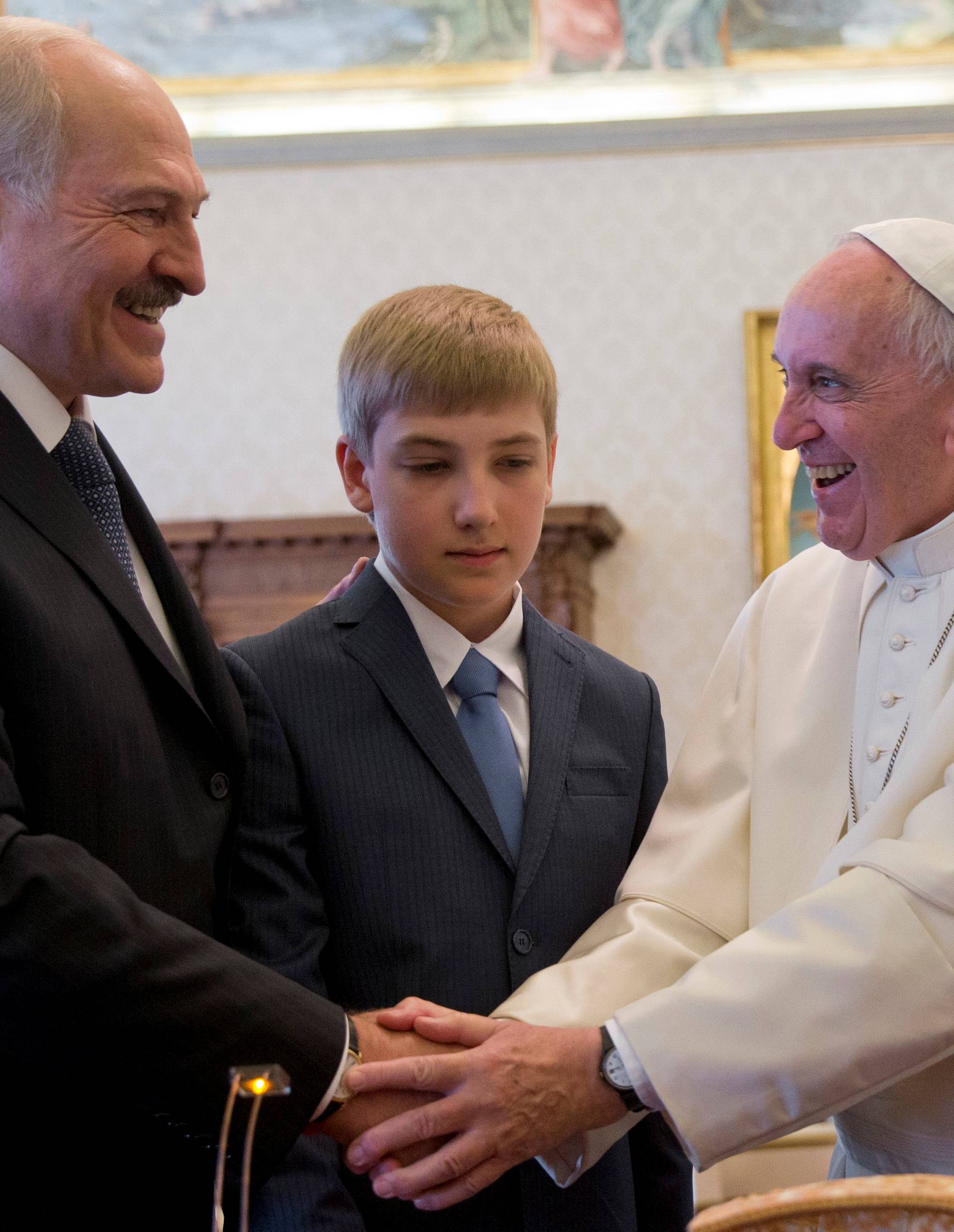 Pope Francis is greeted by Belarussian President Alexander Lukashenko and his son Nikolai during a private audience at the Vatican