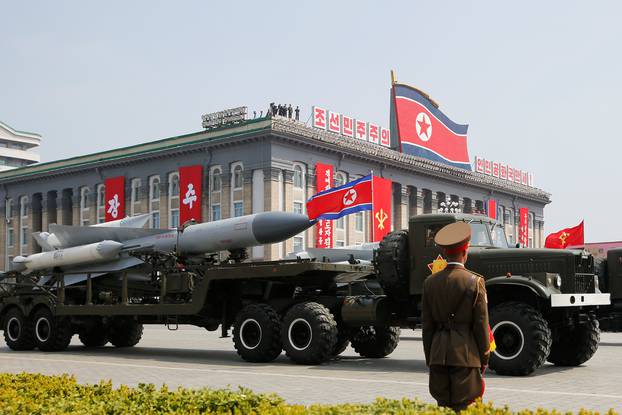 Missiles are driven past the stand with North Korean leader Kim Jong Un and other high ranking officials during a military parade marking the 105th birth anniversary of North Korea